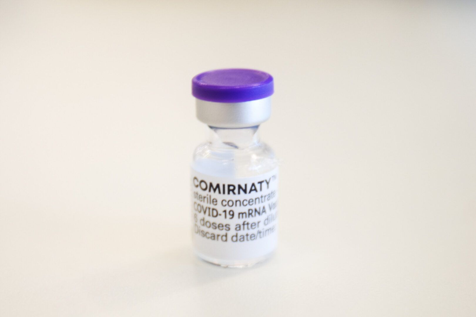 A bottle of Comirnaty Corona Virus vaccine from BionTech / Pfizer stands by the table in the Austria Center Vienna in Vienna on April 02, 2021. The Austria Center is Austria's largest vaccination center